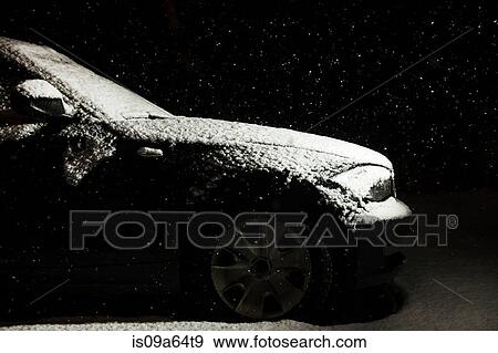 Stock Photo - Snow-covered car in driveway. Fotosearch