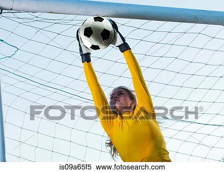 Stock Photography - Soccer player catching ball in goal. Fotosearch