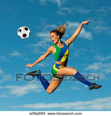 Picture - Soccer player kicking in mid-air. Fotosearch