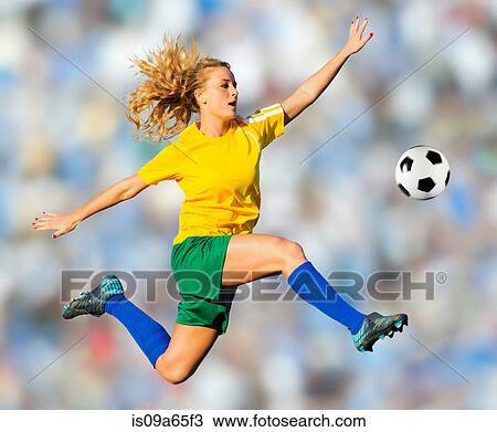 Soccer player kicking in mid-air View Large Photo Image Stock Image - Soccer player kicking in mid-air. Fotosearch