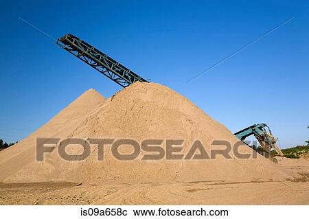 Stacking conveyor and mound of sand View Large Photo Image Stock Image - Stacking conveyor and mound of sand. Fotosearch