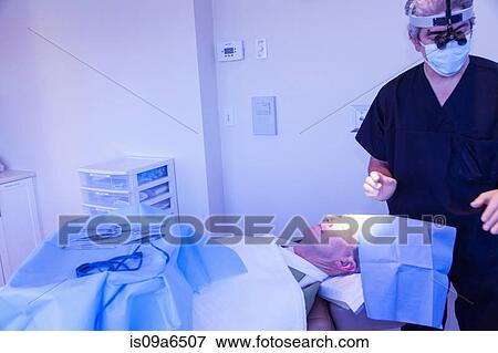Surgeon with patient in operating room View Large Photo Image Stock Photo - Surgeon with patient in operating room. Fotosearch