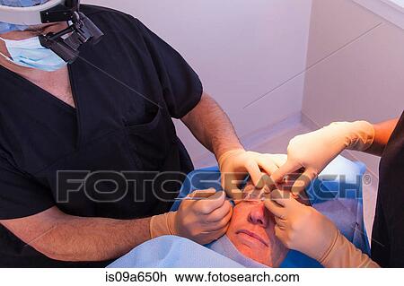Surgeons with patient in operating room View Large Photo Image Stock Image - Surgeons with patient in operating room. Fotosearch