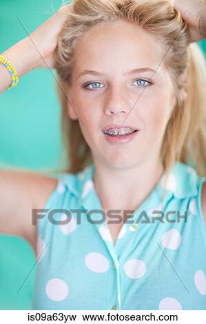 Teenage girl fixing her hair View Large Photo Image Stock Photo - Teenage girl fixing her hair. Fotosearch