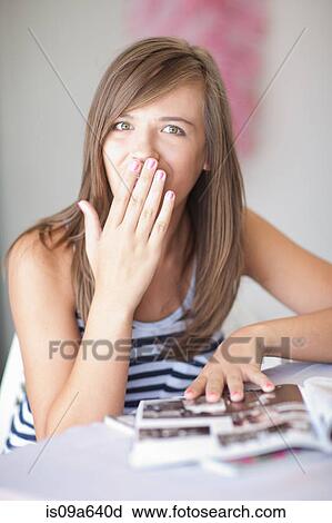 Teenage girl gasping at magazine View Large Photo Image Stock Image - Teenage girl gasping at magazine. Fotosearch