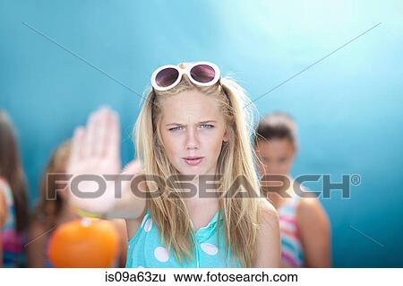 Stock Photograph - Teenage girl holding hand out to stop. Fotosearch