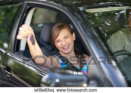 Stock Photography - Teenage girl holding keys to new car. Fotosearch