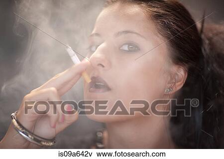 Teenage girl in dark makeup smoking View Large Photo Image Stock Photo - Teenage girl in dark makeup smoking. Fotosearch