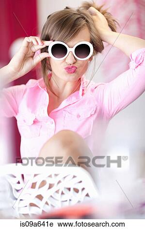 Teenage girl in sunglasses making face View Large Photo Image Stock Image - Teenage girl in sunglasses making face. Fotosearch