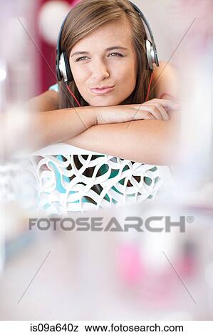Teenage girl listening to headphones View Large Photo Image Stock Photo - Teenage girl listening to headphones. Fotosearch