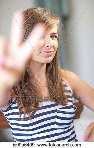 Stock Photo - Teenage girl making peace sign. Fotosearch