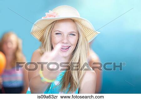 Stock Photography - Teenage girl making rude hand gesture. Fotosearch