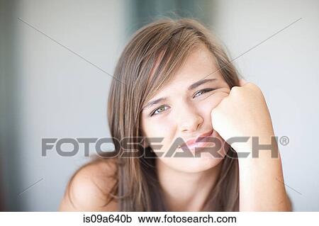 Teenage girl resting cheek on hand View Large Photo Image Stock Image - Teenage girl resting cheek on hand. Fotosearch