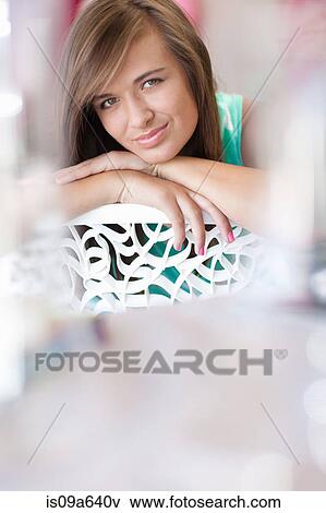 Teenage girl resting chin on hand View Large Photo Image Stock Photo - Teenage girl resting chin on hand. Fotosearch