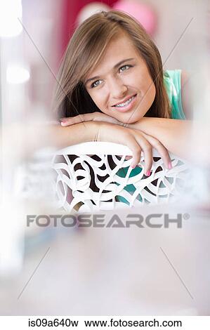 Stock Photo - Teenage girl resting chin on hand. Fotosearch