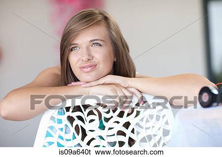 Stock Photograph - Teenage girl resting chin on hand. Fotosearch
