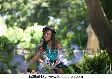 Stock Photo - Teenage girl riding mountain bike. Fotosearch