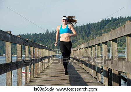 Stock Photo - Teenage girl running together in field. Fotosearch