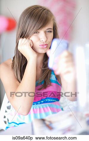 Stock Photography - Teenage girl taking picture of herself. Fotosearch