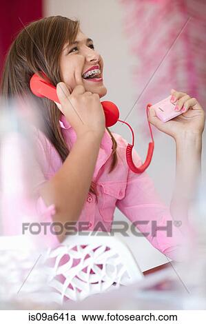 Stock Image - Teenage girl talking on phone. Fotosearch