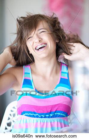 Teenage girl tossing her hair View Large Photo Image Picture - Teenage girl tossing her hair. Fotosearch