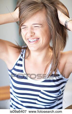 Stock Photo - Teenage girl tossing her hair. Fotosearch