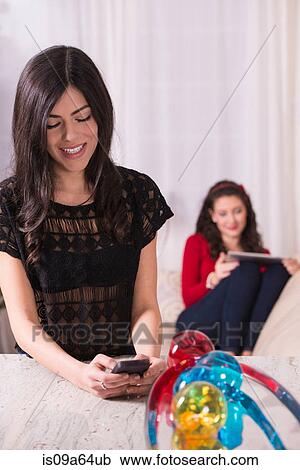 Stock Image - Teenage girl using cell phone. Fotosearch