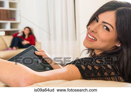 Stock Image - Teenage girl using tablet computer. Fotosearch
