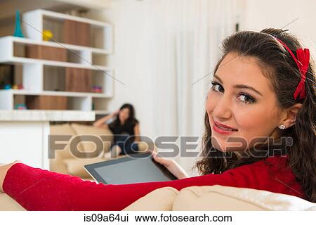 Stock Image - Teenage girl using tablet computer. Fotosearch