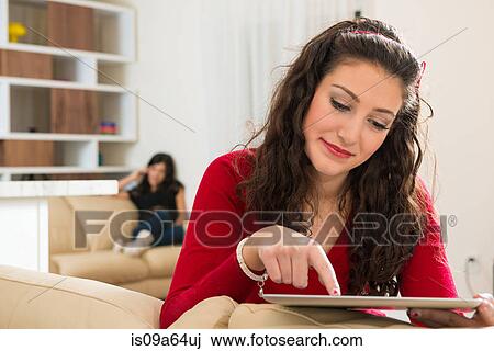 Stock Image - Teenage girl using tablet computer. Fotosearch