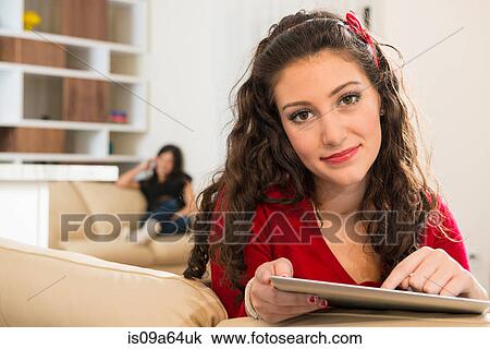 Stock Image - Teenage girl using tablet computer. Fotosearch