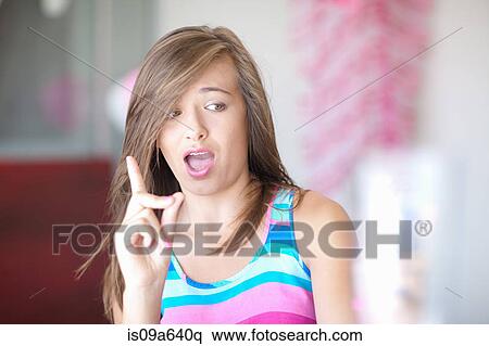 Stock Photography - Teenage girl wagging a finger. Fotosearch