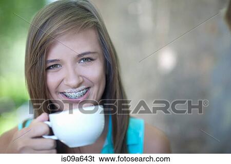 Stock Photograph - Teenage girl with coffee foam mustache. Fotosearch
