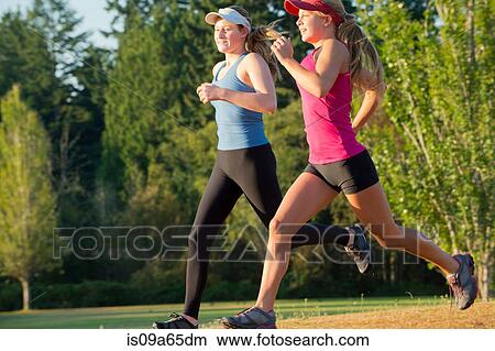 Teenage girls running together in field View Large Photo Image Picture - Teenage girls running together in field. Fotosearch