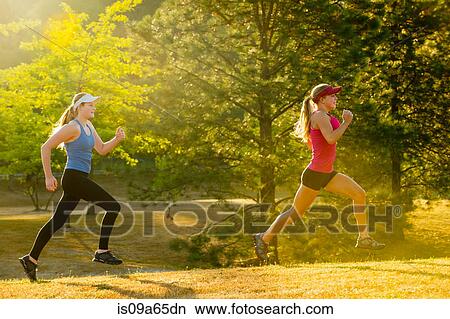Teenage girls running together in field View Large Photo Image Picture - Teenage girls running together in field. Fotosearch