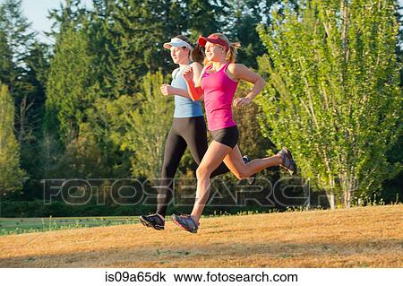 Teenage girls running together in field View Large Photo Image Stock Image - Teenage girls running together in field. Fotosearch