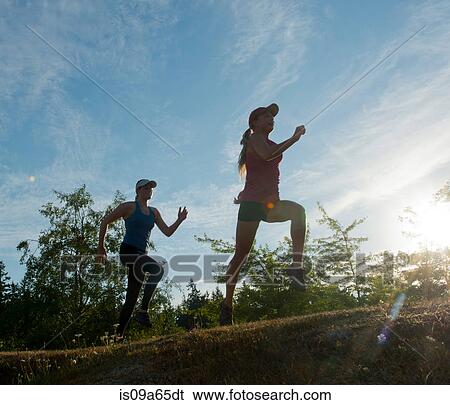 Teenage girls running together in field View Large Photo Image Stock Photograph - Teenage girls running together in field. Fotosearch