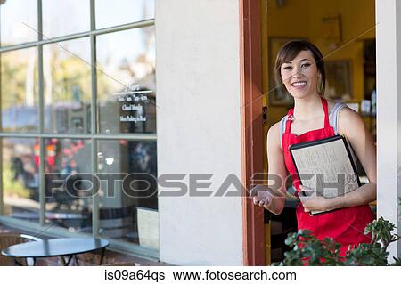 Waitress standing at cafe door View Large Photo Image Stock Photograph - Waitress standing at cafe door. Fotosearch