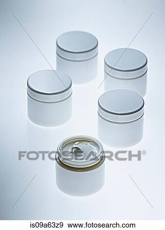 White jars of lotion on counter View Large Photo Image Stock Photo - White jars of lotion on counter. Fotosearch
