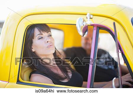 Woman admiring herself in car mirror View Large Photo Image Stock Image - Woman admiring herself in car mirror. Fotosearch