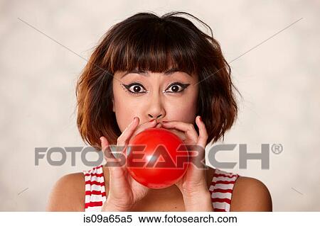 Woman blowing up balloon View Large Photo Image Stock Photography - Woman blowing up balloon. Fotosearch