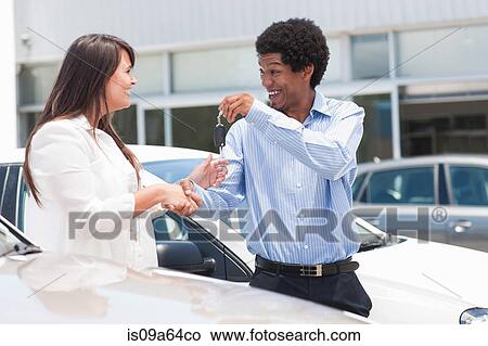 Picture - Woman buying new car from salesman. Fotosearch