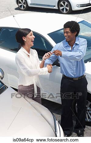 Stock Photography - Woman buying new car from salesman. Fotosearch