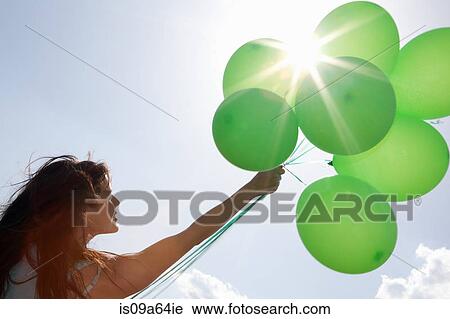 Woman carrying bunch of balloons View Large Photo Image Stock Image - Woman carrying bunch of balloons. Fotosearch