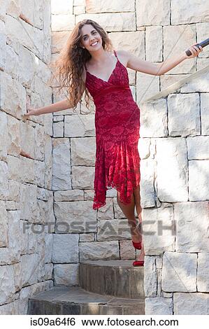 Stock Photograph - Woman climbing stone steps outdoors. Fotosearch