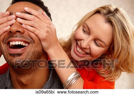 Woman covering boyfriend's eyes View Large Photo Image Stock Image - Woman covering boyfriend's eyes. Fotosearch