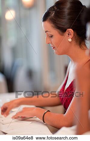 Woman folding her napkin in restaurant View Large Photo Image Stock Photo - Woman folding her napkin in restaurant. Fotosearch