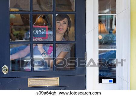 Woman hanging open sign in door View Large Photo Image Stock Image - Woman hanging open sign in door. Fotosearch