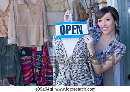Woman hanging open sign on mannequin View Large Photo Image Stock Image - Woman hanging open sign on mannequin. Fotosearch