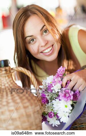 Picture - Woman holding bouquet of flowers. Fotosearch